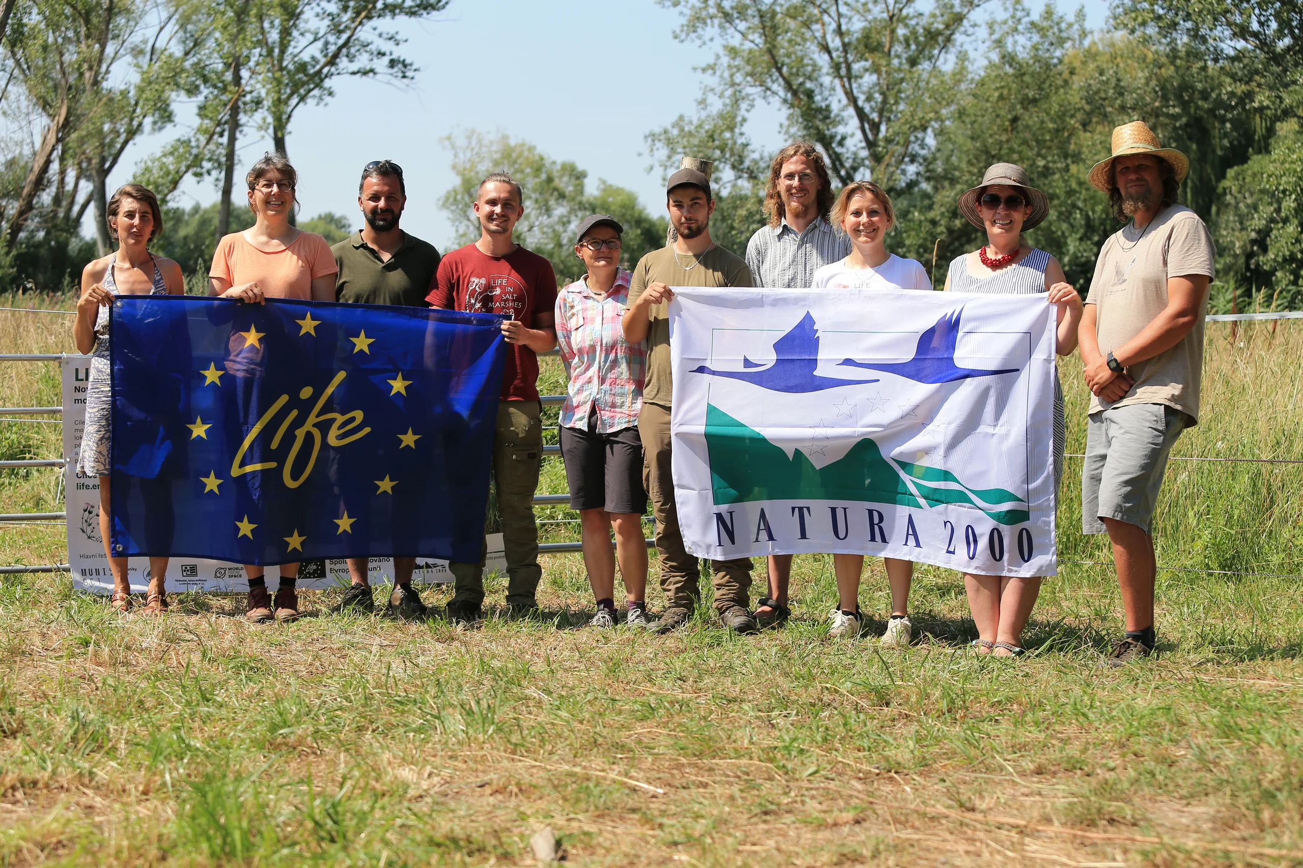 The project team with the LIFE and Natura 2000 banners.